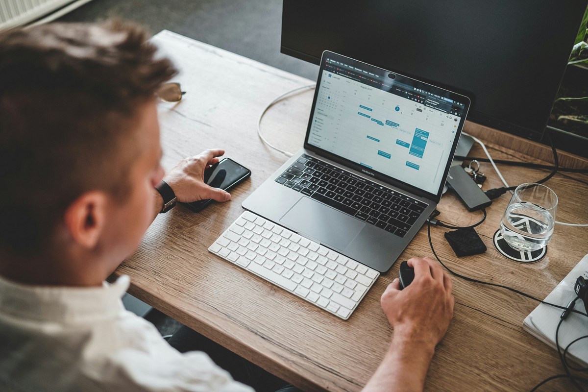 Person working at a desk on a laptop and separate keyboard