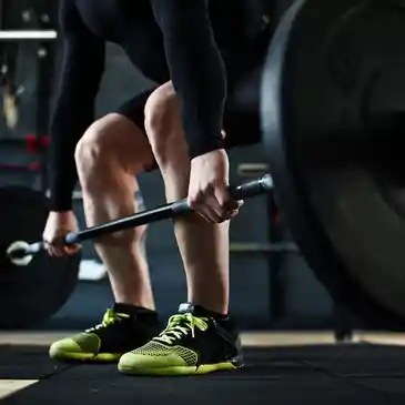 Athlete lifting a barbell in a gym