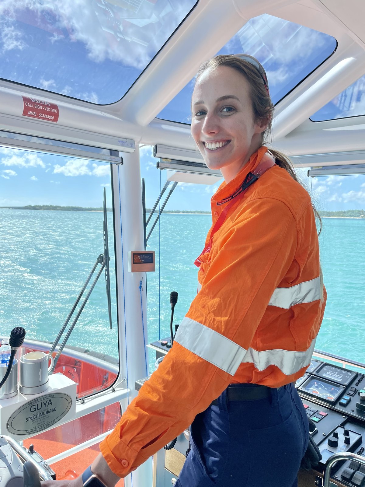 Leanne Wright in hi vis at the helm of a vessel