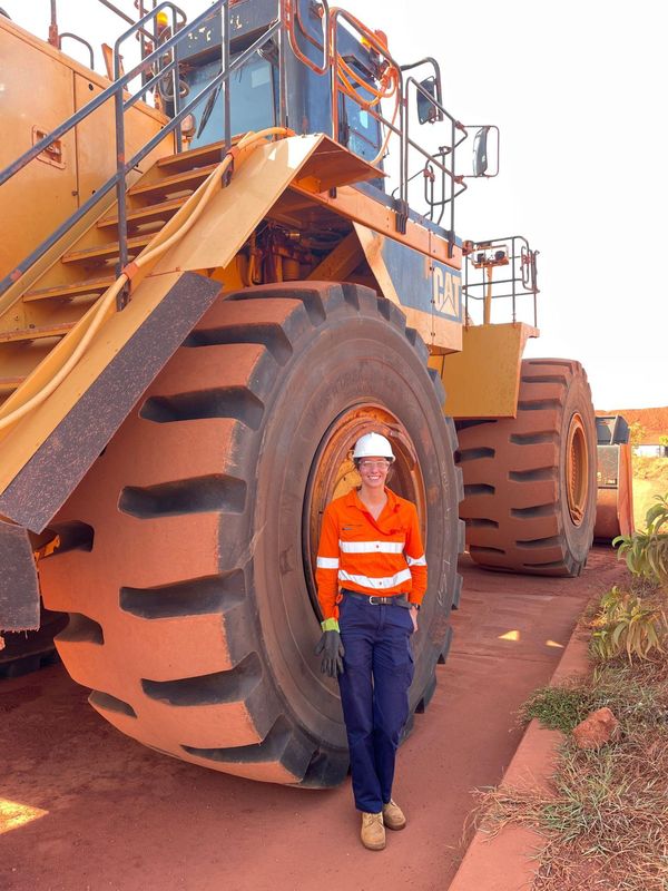 Leanne Wright beside a mine haul truck