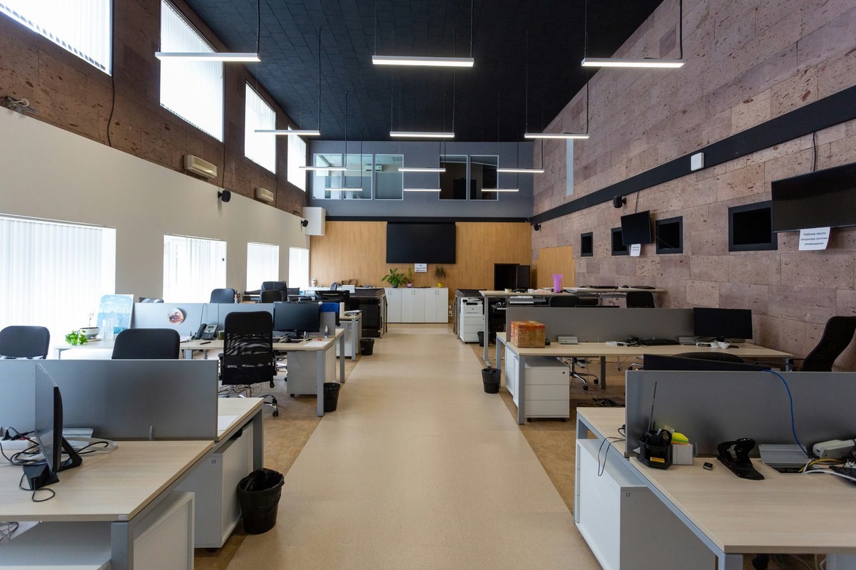 Rows of desks and office chairs in an open plan workspace