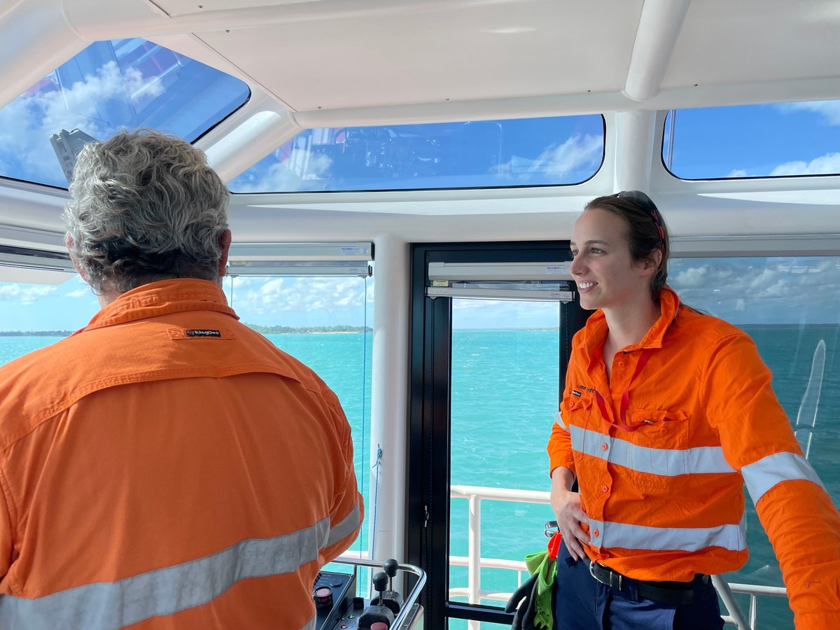 Leanne Wright with a worker in hi vis in a vessel wheelhouse