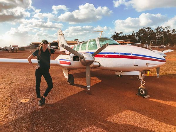 Leanne Wright beside a light aircraft on a remote airstrip