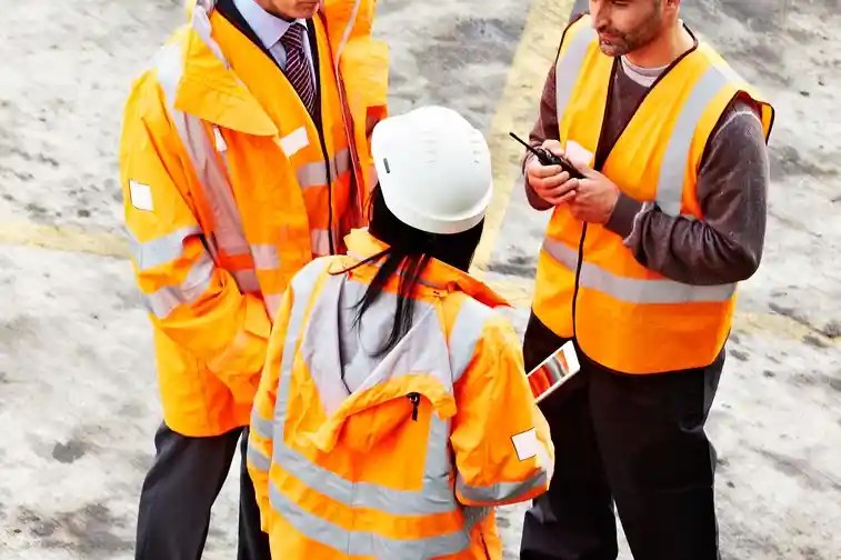 Safety consultation with workers in hi vis on a worksite